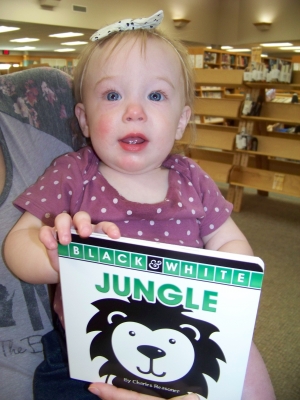 Marcie Tourdot, 9 months, completed the Babies Bloom: 100 Books before One program at the Reedsburg Public Library. Tourdot is holding the book she received for having 100 books read to her before she turned 1. Check out this early literacy program at www.reedsburglibrary.org. (Submitted photo)