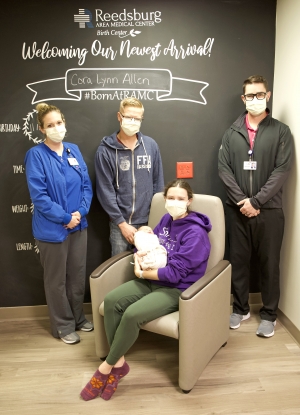Reedsburg Area Medical Center Foundation recently provided glider rockers for each patient room at the RAMC Birth Center. The goal is to continue to make the center more comfortable for mothers, babies and families. Seen here are Tommy and Amanda Allen with baby Cora Lynn Allen, who was born Nov. 12. Also pictured are Erin James, registered nurse and assistant director of the Birth Center, and Ryan Shear, RAMC vice president. In the past, the Foundation has provided multiple gifts to the Birth Center, inclu