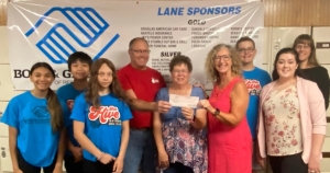 Several residents recently bowled to raise money for the Reedsburg Boys and Girls Club. Bruce Bill from Brewster’s Lanes and event coordinator Carolyn Johnson presented a check for $7,162 to the club. The tournament was held July 18 and included a silent auction and meat raffle. (Submitted photo)
