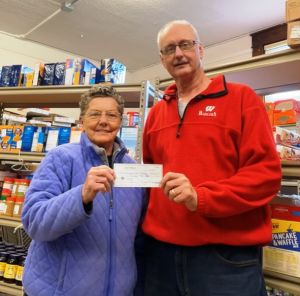 Craig Hillman presents a check to Ann Seamonson from the Reedsburg Food Pantry This donation was made possible through proceeds from the recent hunters night out banquet. It was a combined effort by Jaycees, Knights of Columbus and Reedsburg Outdoor Club. (Submitted photo)