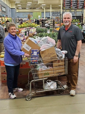 Ann Seamonson, left, accepts a cart full of donations on behalf of the Reedsburg Area Food Pantry. Also seen here is Viking Village Foods Assistant Store Manager Larry Crawford. The food was collected during the Easter Bunny’s visit to Viking on April 9. (Submitted photo)