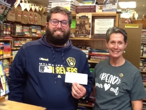 Craig Braunschweig of the Reedsburg Area Historical Society accepts a check from Dana Westedt of Main Street Books. Craig is one of the three authors of “Images of America: Reedsburg,” along with Dave Moon and Kali Hentges. It's a pictorial history of Reedsburg. Books are on sale at the bookstore, and an $8 donation from each book purchased goes to the Historical Society. (Submitted photo)