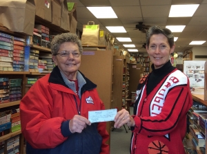 Reedsburg Area Food Pantry representative Ann Seamonson, left, accepts a check for $850 from Main Street Books owner Dana Westedt. The annual Bargain Books Sale, held last November and December, offered customers a wide selection of cookbooks, mysteries, romance, and other excess inventory titles. Stampin' Up stamps by local teacher, Jenny Meacham, also gave customers their choice of card-making rubber stamps. Folks could choose any of the select books and/or stamps and pay whatever amount they could afford