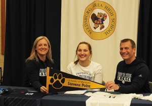 RAHS senior Melissa Klitzke, center, is flanked by her parents at a ceremony last week officially announcing that Klitzke has signed on to play soccer in the fall at UW-Stevens Point. Klitzke, one of the top players in program history in Reedsburg, will play for the Pointers, a D-3 school and a member of the WIAC. (Photo by Troy Matz)