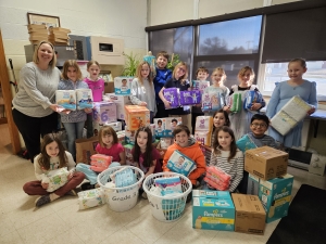 As part of Catholic Schools’ Week, students at Sacred Heart Catholic School in Reedsburg had a diaper and baby wipes drive competition among the grades for the Diaper Closet, which was started by Walking With Moms in Need, (WWMIN). WWMIN is a national initiative of the United States Council of Catholic Bishops (USCCB) focused on supporting pregnant and parenting mothers experiencing hardship. The diaper closet provides essential resources like diapers and wipes. Amanda Munz’s third-grade class brought in th