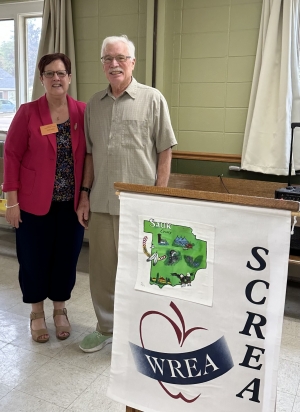The Sauk County Retired Educators met for lunch on Sept. 12 at the United Methodist Church in Reedsburg. Speaker Gary Williams, right, with member Dinah Safford, related his experiences with the Summer Outdoor Adventure Club. This Reedsburg-area youth club attempts to bestow students with a knowledge and love of nature and features summer biking and camping, school field trips and a bicycle-mending shop. (MJ Miller photo)