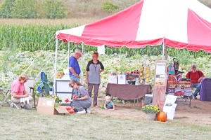People check out produce, flowers and handmade crafts at Country Roots Creations. The farm also has a corn maze this year.