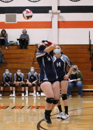 Abbie Spencer, No. 5, bumps the ball for Weston while Saige Allbaugh, No. 14, looks on during last Thursday’s volleyball game at Weston.